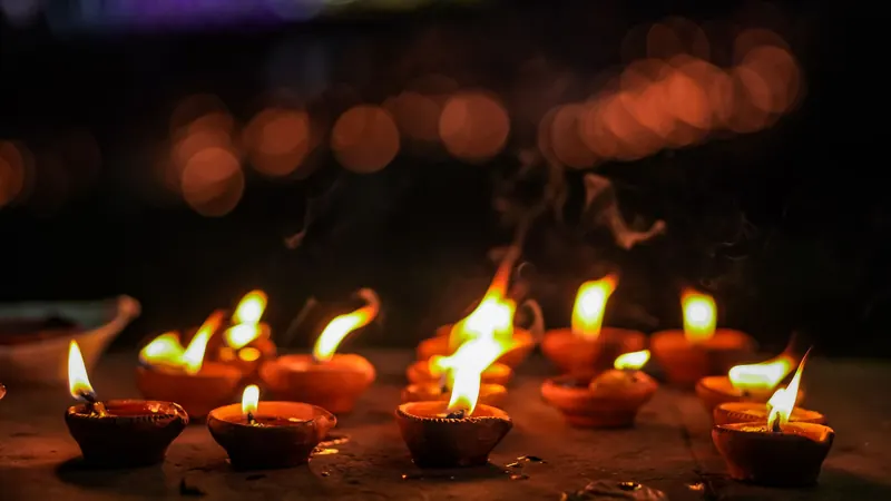 Rows of lit clay oil lamps glowing at night