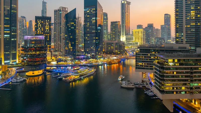 Dubai Marina skyscrapers and waterway lit up at twilight