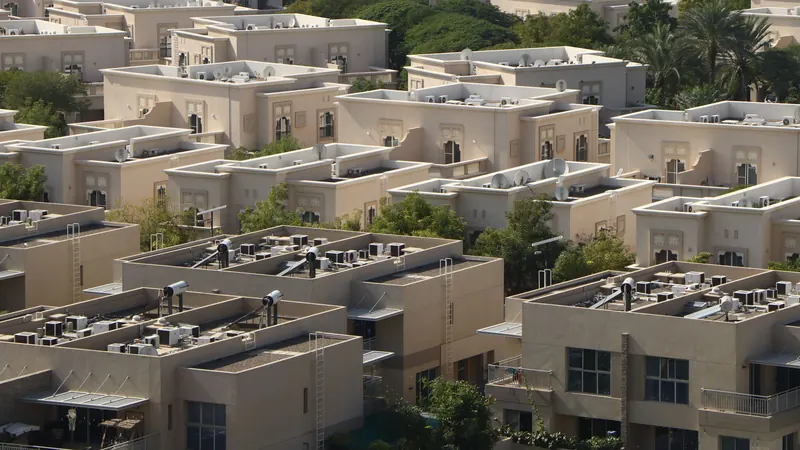 Aerial view of low-rise residential buildings and villas among greenery in Dubai