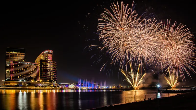 Golden fireworks over a Dubai waterfront at night